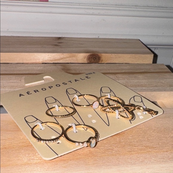 Aeropostale ring Gold toned Set of 7 NEW size 8 for Women - Picture 1 of 1